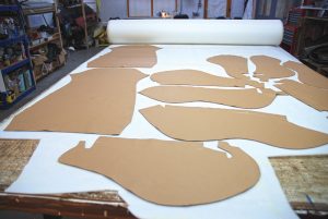 All work is carried out in specific areas of the premises. Here, trim pieces are being cut out from templates.