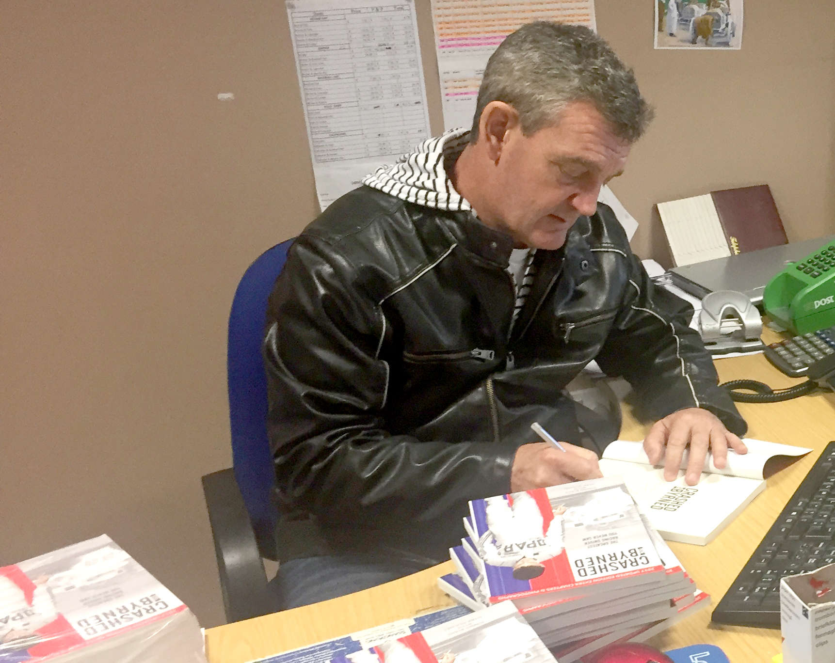 Tommy Byrne singing copies of his book